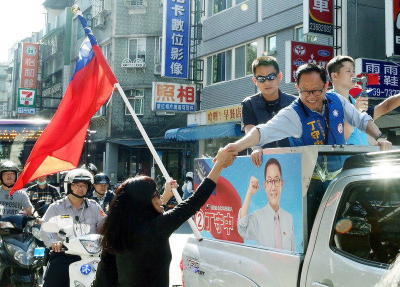 國民黨台北市長候選人丁守中（前右）21日和市議員候選人車隊掃街拜票，盼持續提升支持度。(圖：中央社)